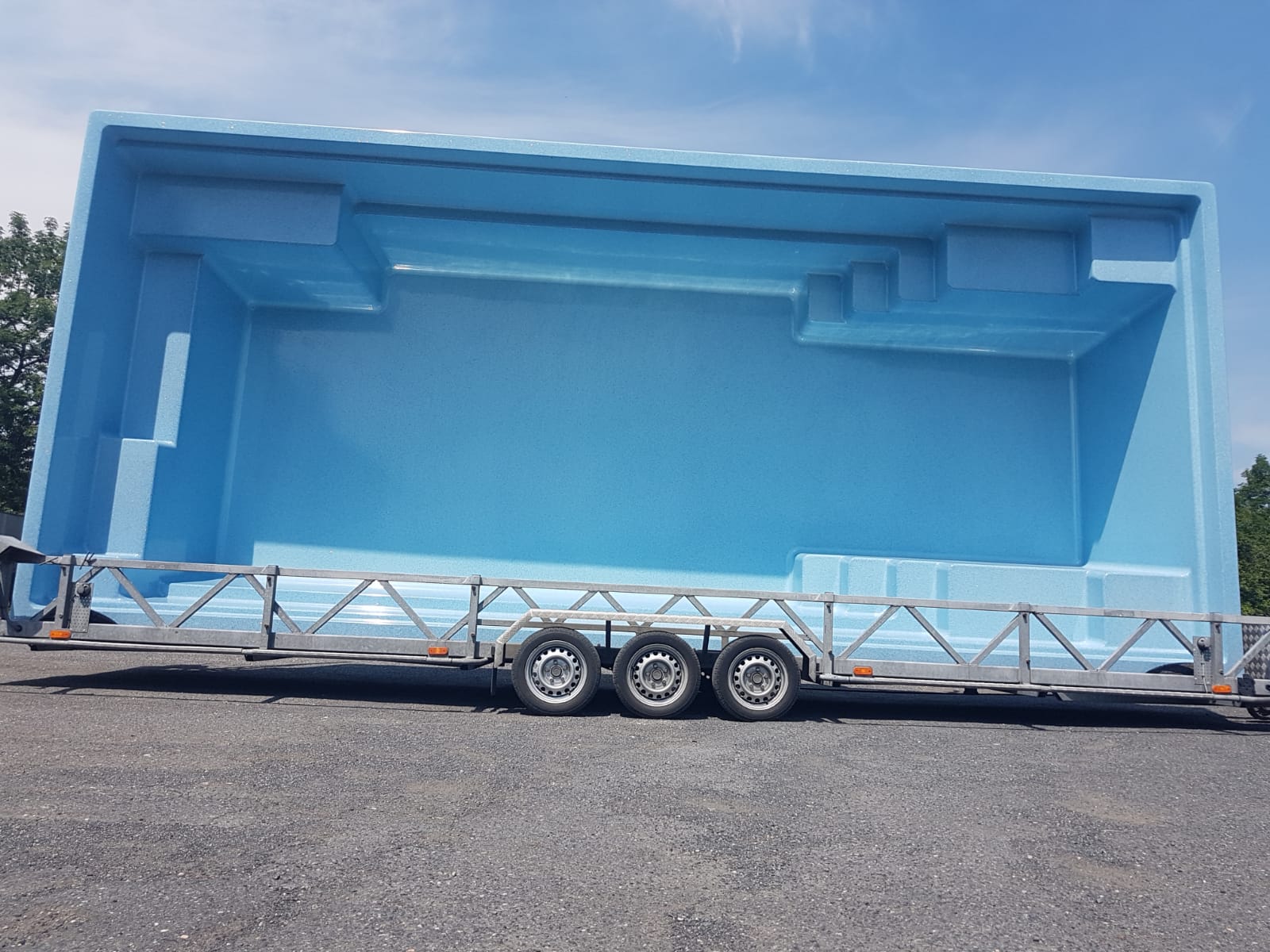 Blaues GFK Ceramic Becken Onyx auf einem Anhänger, bereit für den Transport