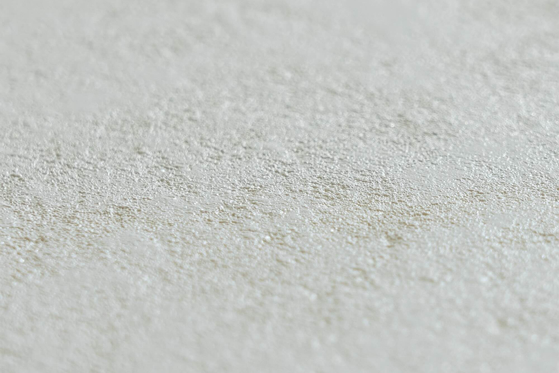 Detailaufnahme der weißen Proflex Stoneflex 3D Schwimmbadfolie in Steinoptik, mit rauer Oberfläche